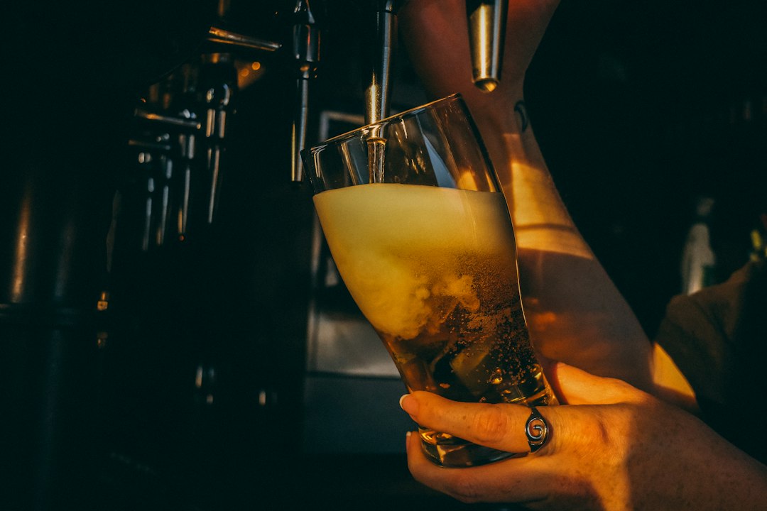 Beer being poured into a glass at a bar